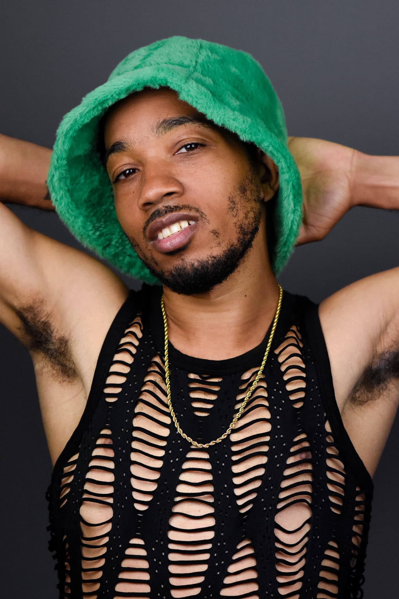 Shaka Walker studio portrait with green bucket hat