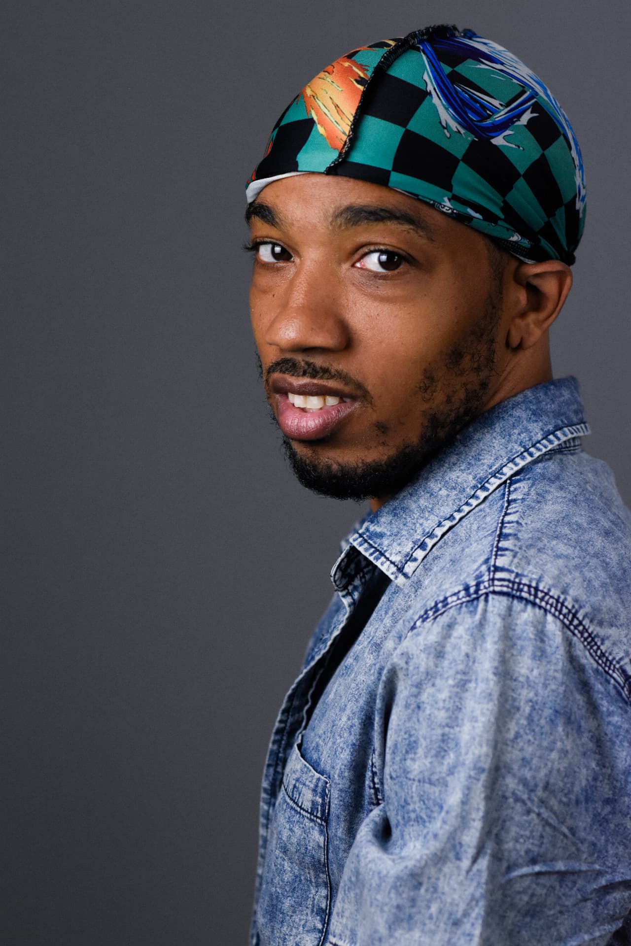 Shaka Walker studio headshot in denim jacket